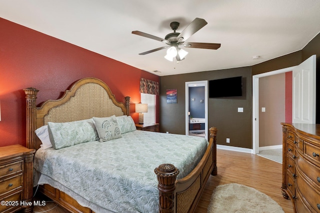 bedroom featuring a ceiling fan, visible vents, light wood-style flooring, and baseboards