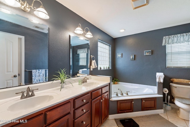 bathroom featuring double vanity, a garden tub, tile patterned flooring, and a sink