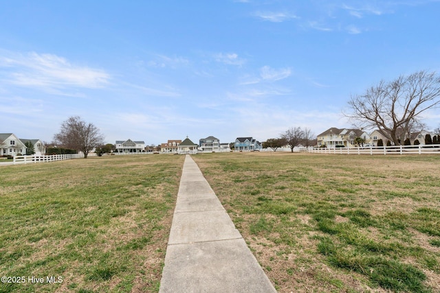 view of yard with a residential view and fence