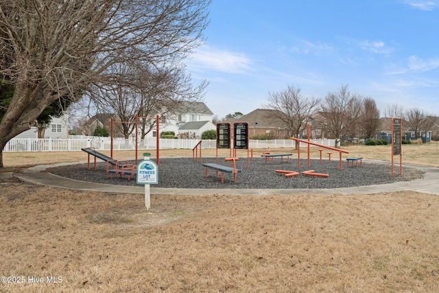 view of playground featuring fence and a lawn