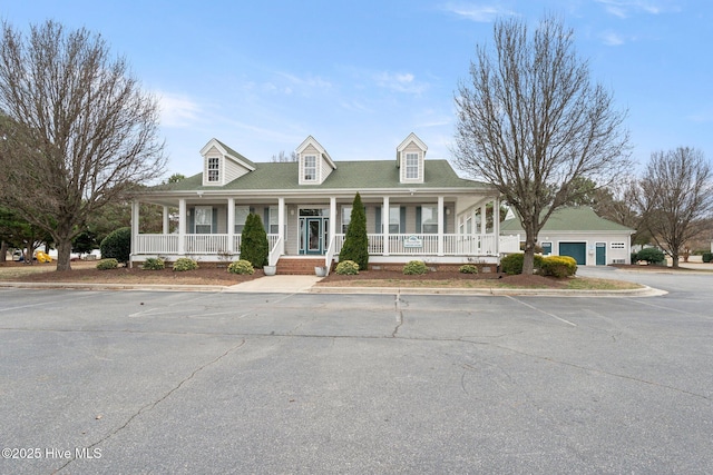 view of front of property featuring uncovered parking and covered porch