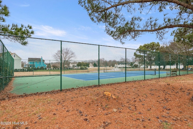 view of sport court featuring fence