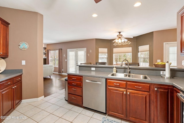 kitchen with plenty of natural light, open floor plan, a sink, and stainless steel dishwasher