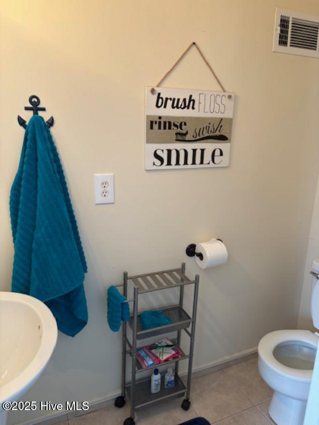 bathroom featuring tile patterned floors, toilet, and sink