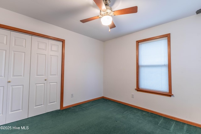 unfurnished bedroom featuring ceiling fan, dark colored carpet, a closet, and baseboards