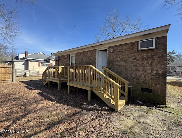 rear view of house featuring a wooden deck