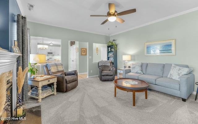 living area with light carpet, baseboards, visible vents, a ceiling fan, and crown molding