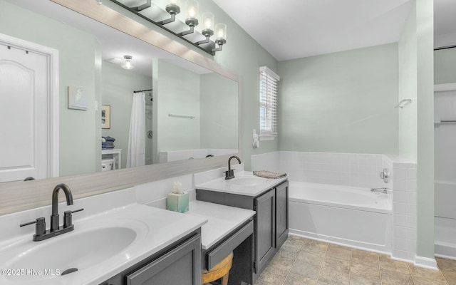 bathroom with two vanities, a sink, and a bath