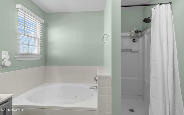 full bathroom with a jetted tub, a shower stall, and vanity