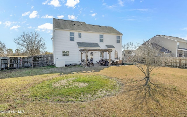 back of house featuring a fenced backyard, a patio, a pergola, and a yard