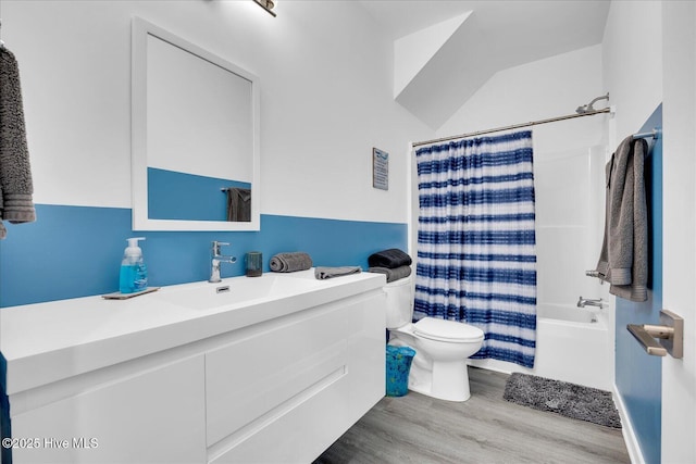 full bathroom with vanity, shower / bath combination with curtain, wood finished floors, and toilet