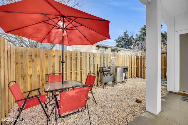 view of patio / terrace with outdoor dining space, fence, and area for grilling