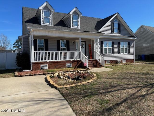 cape cod-style house with a front lawn and a porch