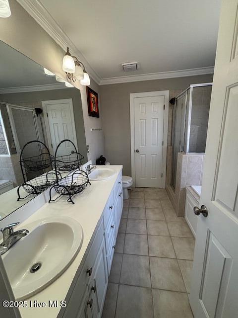 full bathroom with separate shower and tub, toilet, crown molding, tile patterned floors, and vanity