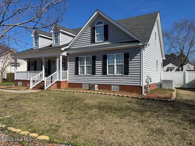 cape cod home with central AC, a porch, and a front yard