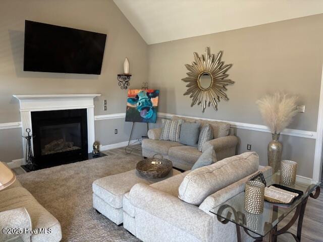 living room featuring carpet floors and lofted ceiling