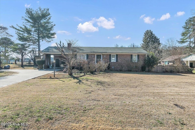 ranch-style house featuring a carport and a front lawn