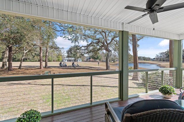 exterior space featuring a water view and ceiling fan