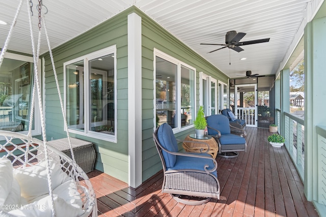 wooden deck with covered porch and ceiling fan