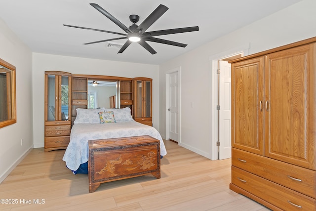 bedroom featuring visible vents, ceiling fan, light wood-style flooring, and baseboards