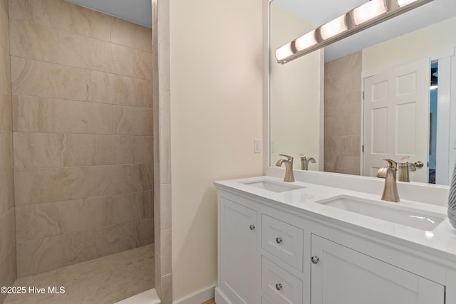 full bath with double vanity, a sink, and a walk in shower