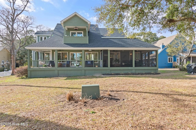 back of house with a lawn and a sunroom