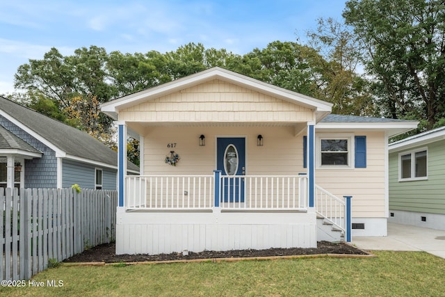 bungalow-style house with covered porch and a front lawn