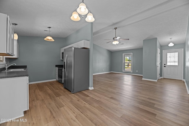 kitchen featuring stainless steel fridge with ice dispenser, a sink, ceiling fan, dark countertops, and white cabinetry