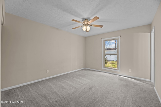 carpeted spare room with baseboards, a textured ceiling, and ceiling fan