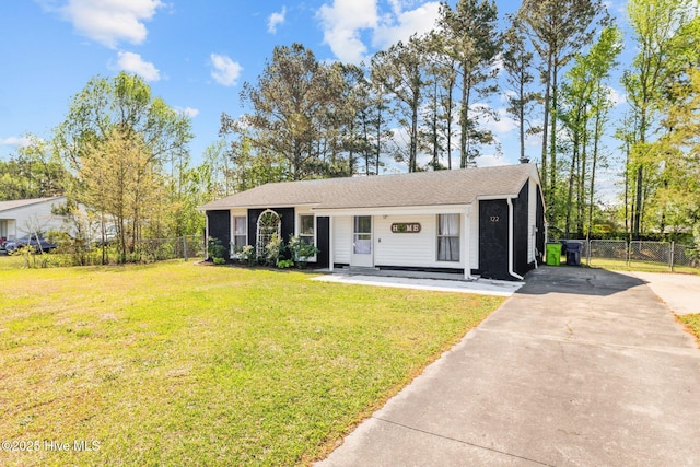 view of front of home with driveway, fence, and a front lawn