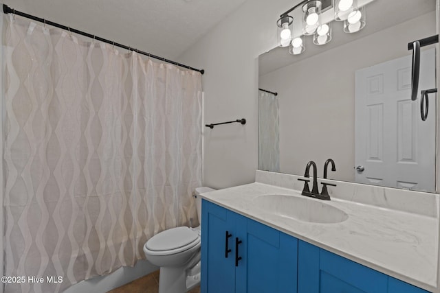 full bath with tile patterned floors, vanity, and toilet