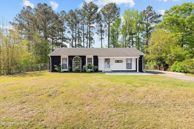 ranch-style home with a front yard and fence