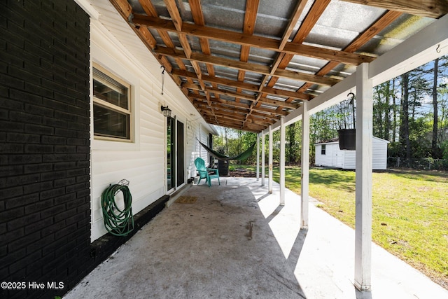 view of patio featuring an outbuilding and a storage unit