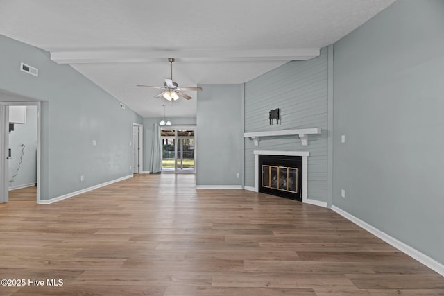 unfurnished living room with ceiling fan, lofted ceiling with beams, visible vents, light wood finished floors, and baseboards
