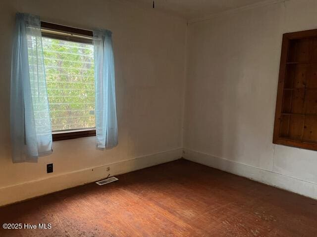 unfurnished room with dark wood-type flooring