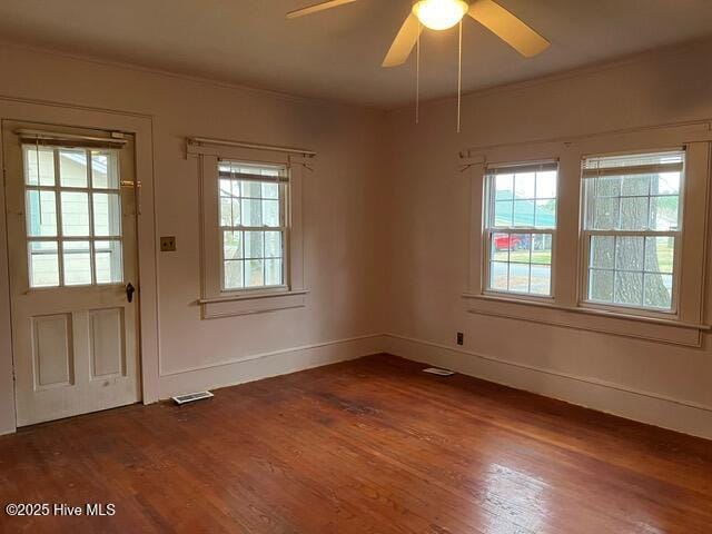 interior space with ceiling fan, crown molding, and dark hardwood / wood-style flooring