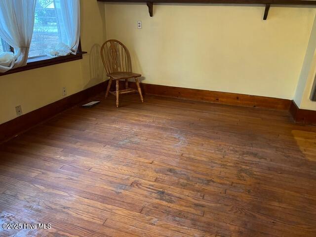 unfurnished room featuring dark hardwood / wood-style flooring