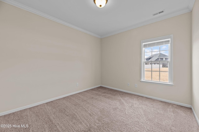 carpeted empty room with baseboards, visible vents, and crown molding