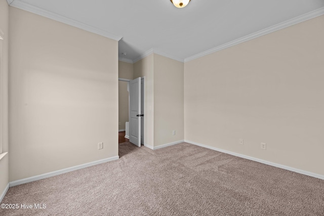 unfurnished room with baseboards, ornamental molding, and carpet flooring