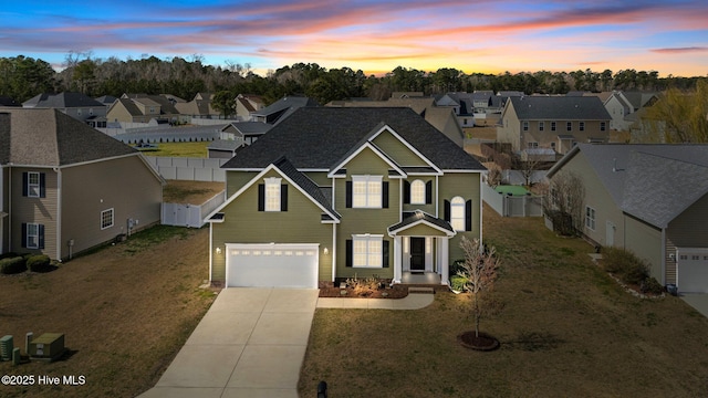 view of front facade with driveway, an attached garage, a residential view, and fence