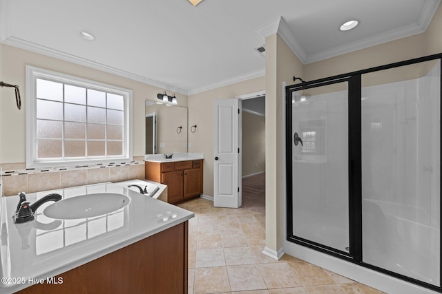 full bath featuring ornamental molding, a stall shower, and two vanities