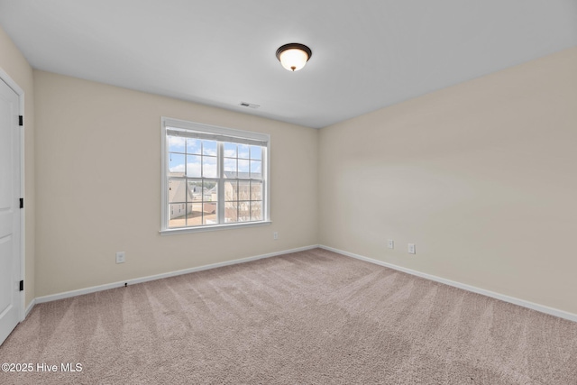 carpeted spare room with baseboards and visible vents