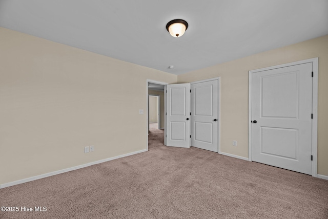 unfurnished bedroom with carpet flooring and baseboards