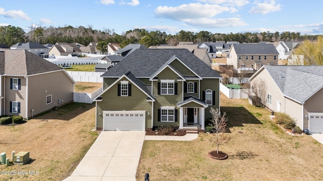 view of front of home featuring a garage, fence, driveway, roof with shingles, and a residential view