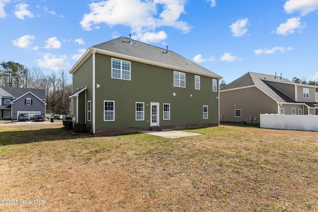 back of house featuring a yard, fence, and a patio