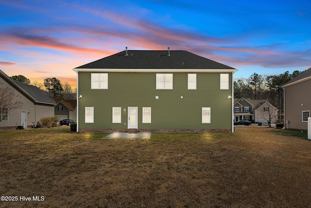 back of house featuring a patio and a lawn