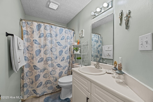 full bath with a textured ceiling, curtained shower, toilet, vanity, and tile patterned floors