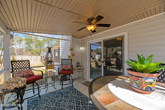 view of patio featuring fence and ceiling fan