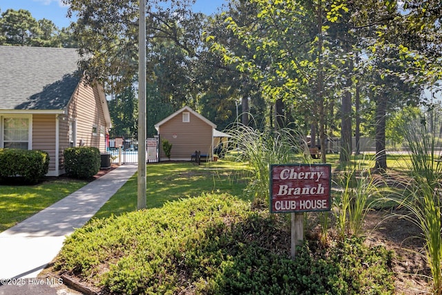 view of community with a gate and a lawn