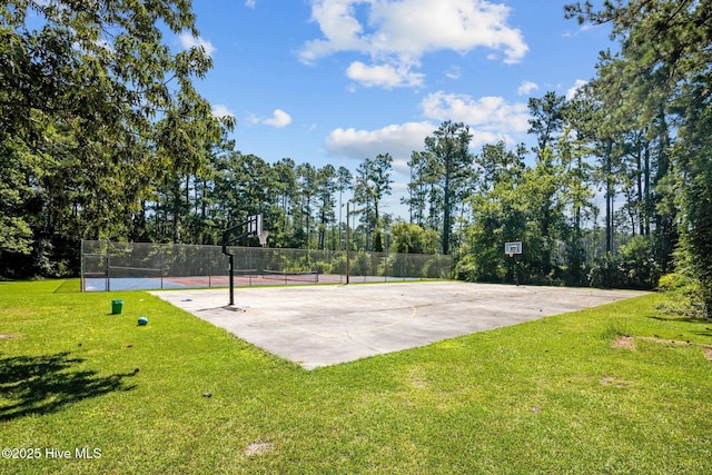 surrounding community featuring a yard, community basketball court, a tennis court, and fence